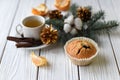 A Christmas composition with a cup of tea, homemade muffins, cones, fur twigs and cinnamon sticks Royalty Free Stock Photo