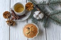 A Christmas composition with a cup of tea, homemade muffins, cones, fur twigs and cinnamon sticks Royalty Free Stock Photo