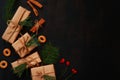 Christmas composition on a dark wooden background, top view. Several gift boxes