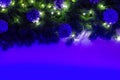 Christmas composition is decorated with a garland, glass balls and decorative pine cones. Bright neon light illuminates Royalty Free Stock Photo