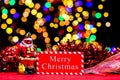 Christmas composition with a decorative Santa, tinsel, and blurred lights in the background Royalty Free Stock Photo