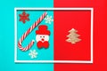 Christmas composition with decorative snowman, lollipop and snowflakes colorful background with white frame. Winter holiday Royalty Free Stock Photo