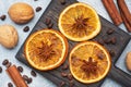 Christmas composition with dried oranges, cinnamon, anise and nuts on a gray concrete background. Flat lay top view Royalty Free Stock Photo