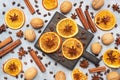 Christmas composition with dried oranges, cinnamon, anise and nuts on a gray concrete background. Flat lay top view Royalty Free Stock Photo