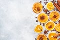 Christmas composition with dried oranges, cinnamon, anise and nuts on a gray concrete background. Flat lay top view. Copy space Royalty Free Stock Photo