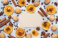 Christmas composition with dried oranges, cinnamon, anise and nuts on a gray concrete background. Flat lay top view. Copy space Royalty Free Stock Photo