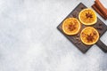 Christmas composition with dried oranges, cinnamon, anise and nuts on a gray concrete background. Flat lay top view. Copy space Royalty Free Stock Photo