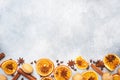 Christmas composition with dried oranges, cinnamon, anise and nuts on a gray concrete background. Flat lay top view. Copy space Royalty Free Stock Photo