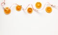 Christmas composition with dried oranges slices on white background. Natural dry food ingredient for cooking or Christmas decor