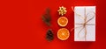 Christmas composition with eco crafted gift, dried orange, cone, xmas tree, gift and gold bow. Natural and minimal new