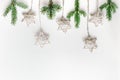 Christmas composition in Eco style. Fir branches and handmade stars on a white background.