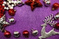Christmas composition with ellk and Red Christmas balls with space copy on Purple glitter background Royalty Free Stock Photo