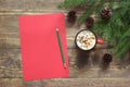 Christmas composition. Empty red blank for wishing to Santa and cup of coffee on the wooden. Top view with copy space. Royalty Free Stock Photo