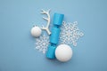 Christmas composition. Festive cracker with winter snowflake, antler and balls