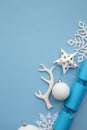 Christmas composition. Festive cracker with winter snowflake, antler and balls