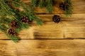 Christmas composition with fir tree branches and cones on wooden background. Top view, copy space Royalty Free Stock Photo