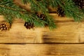 Christmas composition with fir tree branches and cones on wooden background. Top view, copy space Royalty Free Stock Photo