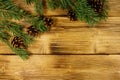 Christmas composition with fir tree branches and cones on wooden background. Top view, copy space Royalty Free Stock Photo