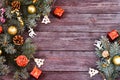 Christmas composition. fir tree branches, golden balls, New Year toys, confetti on a wooden background Royalty Free Stock Photo
