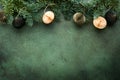 Christmas composition. Christmas fir tree branches with pine cones and papers rustic balls on old green concrete rustic background Royalty Free Stock Photo