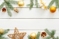 Christmas composition. Flatlay golden decorations, balls, stars, pine tree branch on white wooden background. Flat lay, top view, Royalty Free Stock Photo