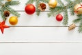 Christmas composition. Frame border made of Christmas decorations, red star, gold balls, cones on white wooden background. Flat Royalty Free Stock Photo