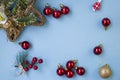 Christmas composition. Frame from branches of a Christmas tree, red and gold decorations and red berries on a white background. Royalty Free Stock Photo