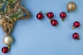 Christmas composition. Frame from branches of a Christmas tree, red and gold decorations and red berries on a white background. Royalty Free Stock Photo