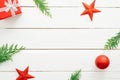 Christmas composition. Frame made of Christmas decorations, red balls. stars, fir tree branches on wooden white background. Royalty Free Stock Photo