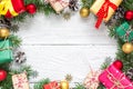 Christmas composition. frame made of fir branches, gift boxes, decorations and pine cones on white wooden table Royalty Free Stock Photo