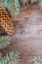 Christmas composition: Fresh branches of blue spruce with cones on aged wooden background. Top view