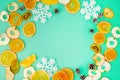 Christmas composition. Fruits, Snowflakes, Fir Cones on green background. Fruit and holiday pattern. Flat lay, top view, copy