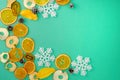 Christmas composition. Fruits, snowflakes, fir cones on green background. Christmas, winter and new year concept. Top view, copy