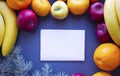 Christmas composition of fruits  white empty leaf in the middle of a Christmas tree around apples  tangerines  bananas Royalty Free Stock Photo