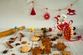 Funny rat in a chef`s hat and apron with homemade gingerbread, spices, rolling pin, red ribbons and felt toys. Royalty Free Stock Photo