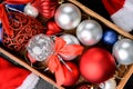 Christmas composition. Christmas gift, balls, in wooden box , top view flat lay, on black wooden table background Royalty Free Stock Photo