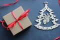 Christmas composition. Gift box with red satin ribbon, tree and snowflakes on black background. Royalty Free Stock Photo