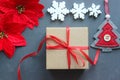 Christmas composition. Gift box with red satin ribbon, wood and snowflakes on black background. Toys Christmas decor. Royalty Free Stock Photo