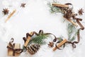 Christmas and New Year composition. Gift box with ribbon, fir branches with cones, star anise, cinnamon on white background Royalty Free Stock Photo