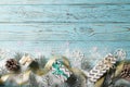 Christmas composition from gift box, snow, pine cone, fir branches on a blue wooden background Royalty Free Stock Photo