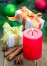 Christmas composition with gift box, spices and candle Royalty Free Stock Photo