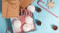 Christmas composition with gift boxes, candy cane, gingerbread, snowflakes on a light blue background Royalty Free Stock Photo