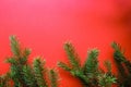 Christmas composition with gift boxes, clews of rope, paper`s rools and decorations, fir tree branches on red background.