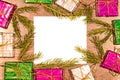 Christmas composition with gift boxes, fir branches and empty sheet of paper on wooden board Royalty Free Stock Photo