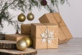 Christmas composition, gifts in craft packaging, golden balls, fir branch, white background