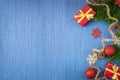 Christmas composition with gifts, gold tinsel, pine cones, fir branches and snowflakes on a blue background Royalty Free Stock Photo