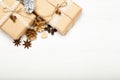 Christmas composition, Christmas gifts, golden pine cones on white wooden background.