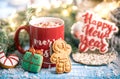 Christmas composition with gingerbread cookies and red cup of hot drink on blurred background Royalty Free Stock Photo