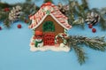 Christmas composition gingerbread house on the blue background of a winter spruce. Close-up. The concept of Christmas and New Yea Royalty Free Stock Photo