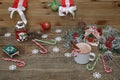 Christmas composition with gingerbread house, mug of chocolate cocoa, caramel sugar canes and decorations on wooden background Royalty Free Stock Photo